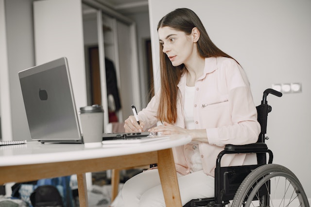 https://www.pexels.com/photo/a-woman-on-a-wheelchair-working-7446646/